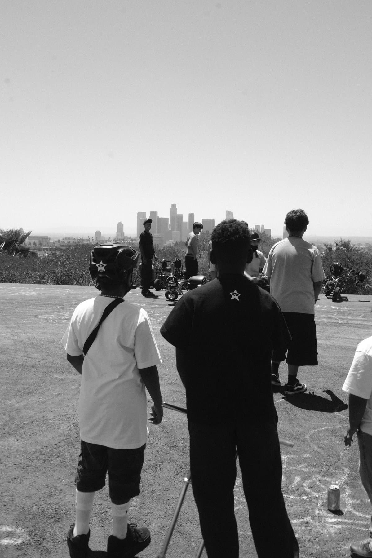 Young men looking out over the Los Angeles skyline.